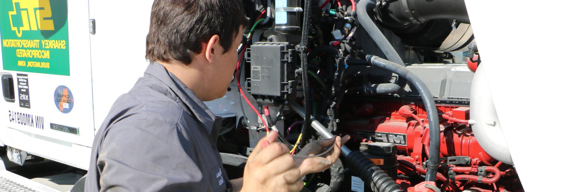 student working on a diesel